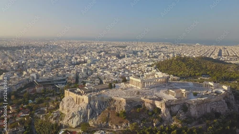 The Acropolis of Athens, Greece, with the Parthenon Temple during sunset (aerial view) The Acropolis of Athens, Greece, with the Parthenon Temple during sunset (aerial view)
