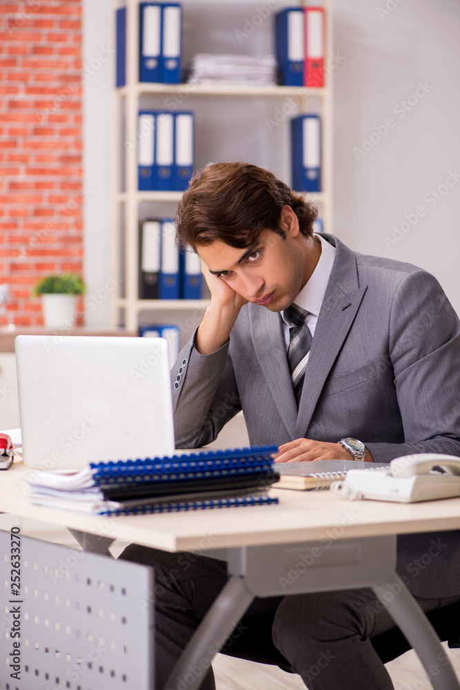 Young businessman working in the office Young businessman working in the office