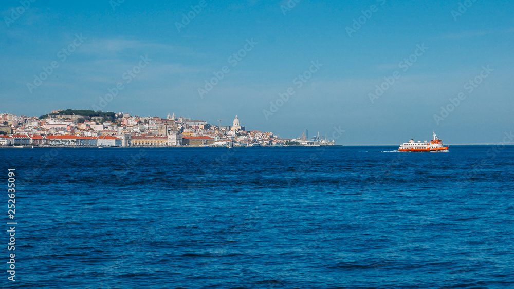 High perspective panorama of Lisbon old city center, view from Almada, Portugal with ferry boat crossing