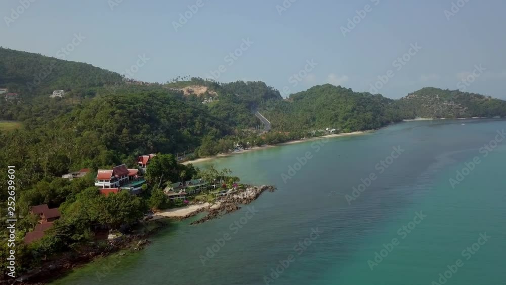 Aerial View of Residental Area with Accommodation and Transport Moving along Road near White Sandy Beach and Sea Shore. Infrastructure on Tropical Island in Thailand Aerial View of Residental Area with Accommodation and Transport Moving along Road near White Sandy Beach and Sea Shore. Infrastructure on Tropical Island in Thailand