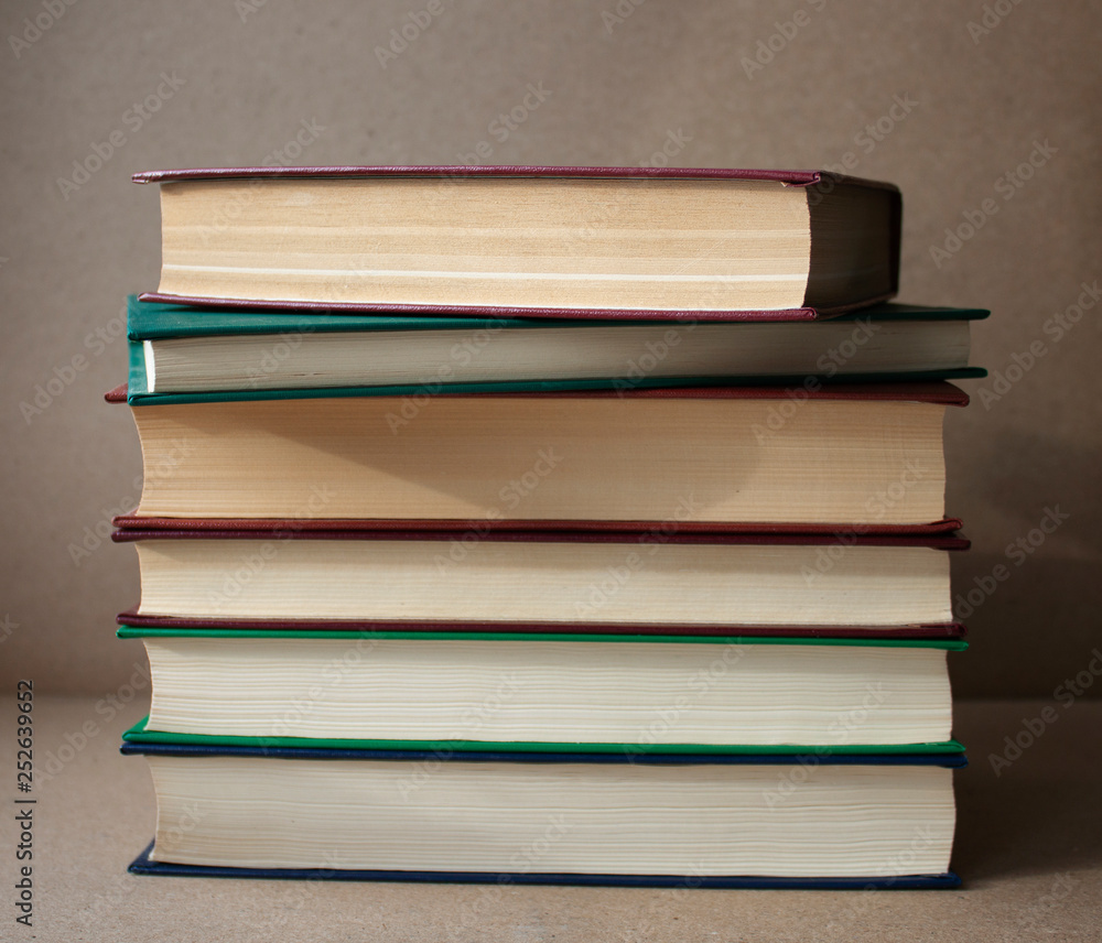 A stack of books on a crafting background. Education. Literature. Home library A stack of books on a crafting background. Education. Literature. Home library