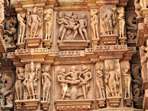 Sex poses from the kamasutra, erotic close - up of intricate carved scenes on the walls of Hindu temples in the Western group of Khajuraho, India photo