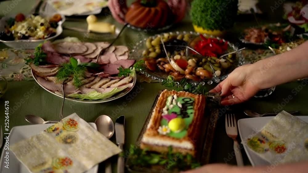 Closeup of hands putting salad on table during easter brekfast, super slow motion Closeup of hands putting salad on table during easter brekfast, super slow motion