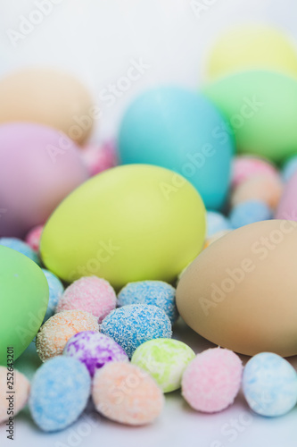 Colorful Assorted sizes Pastel Happy Easter Eggs sunny background with copy space