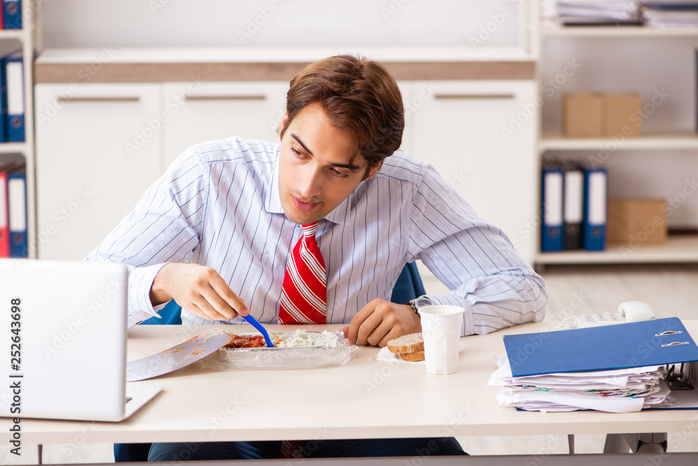 Man having meal at work during break