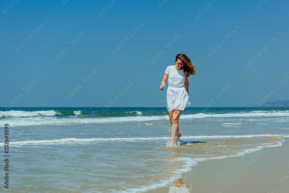 Beautiful Girl in White Dress Enjoy and Relax on The Beach. Travel and Vacation. Beautiful Girl in White Dress Enjoy and Relax on The Beach. Travel and Vacation.