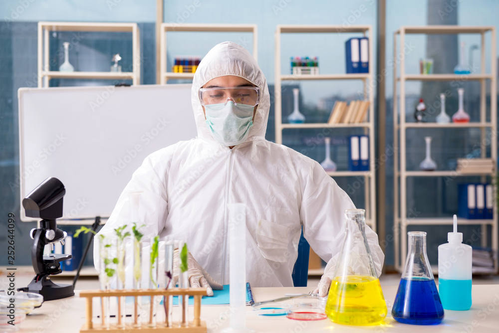 Male biotechnology scientist chemist working in the lab Male biotechnology scientist chemist working in the lab
