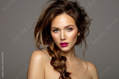 Beauty portrait of female model with messy hair and braid
