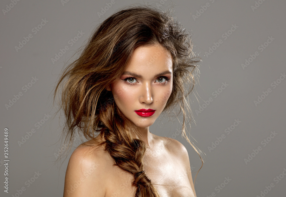 Beauty portrait of female model with braid isolated on gray background