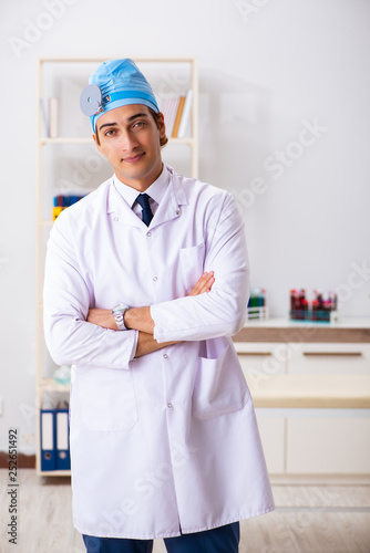 Young male doctor otolaryngologist working at the hospital 