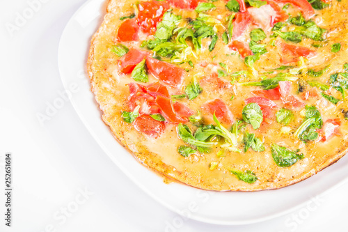 Omelette with tomatoes and fresh corn salad on a white background