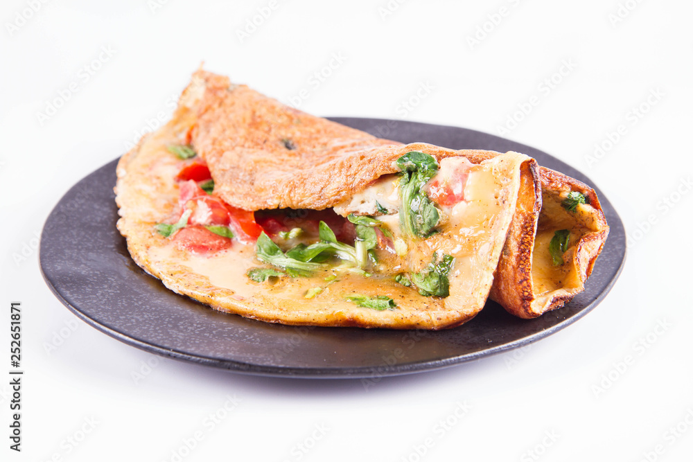 Omelette with tomatoes and fresh corn salad on a white background Omelette with tomatoes and fresh corn salad on a white background
