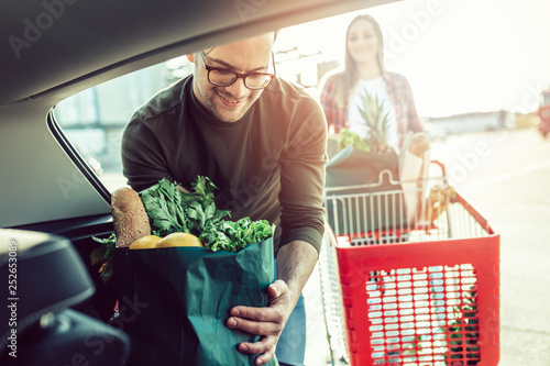 Husband and his wife after buying food in grocery store or supermarket.