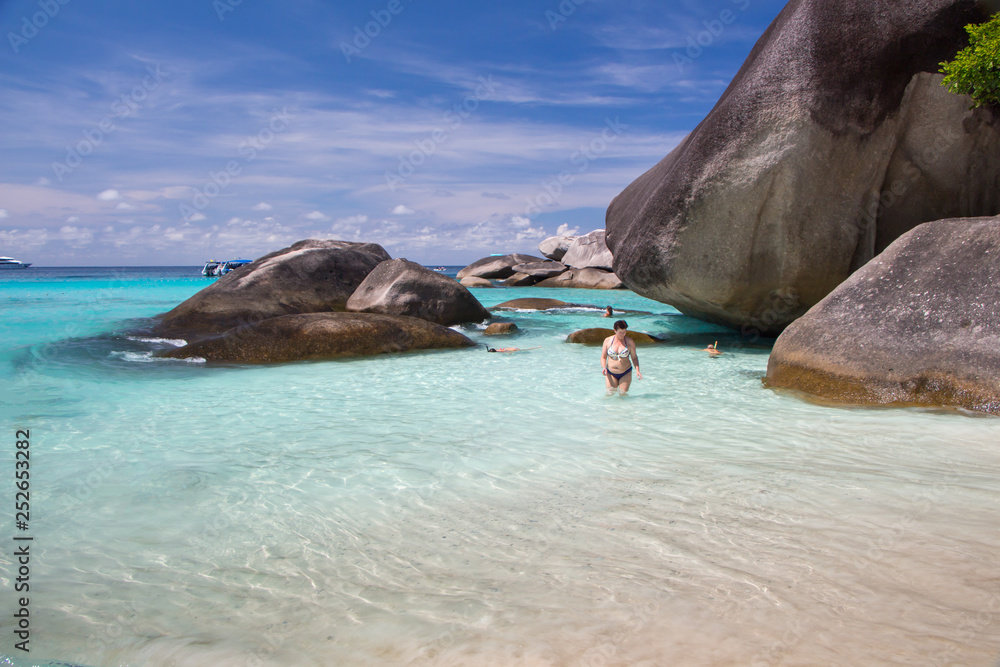 Fototapeta premium beach in the lagoon with white sand rocky shore and tourists