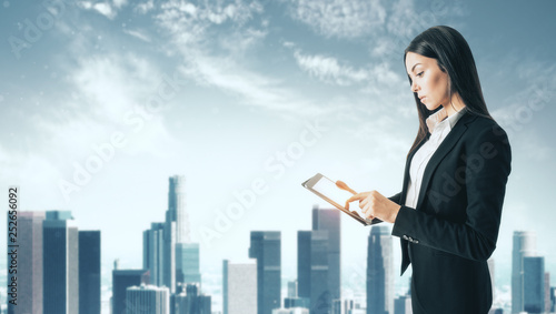 Woman using tablet in city