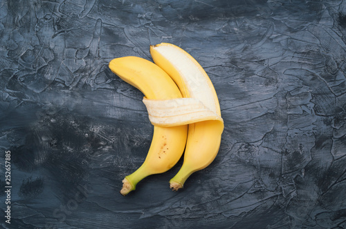 Two bananas isolated on dark background photo
