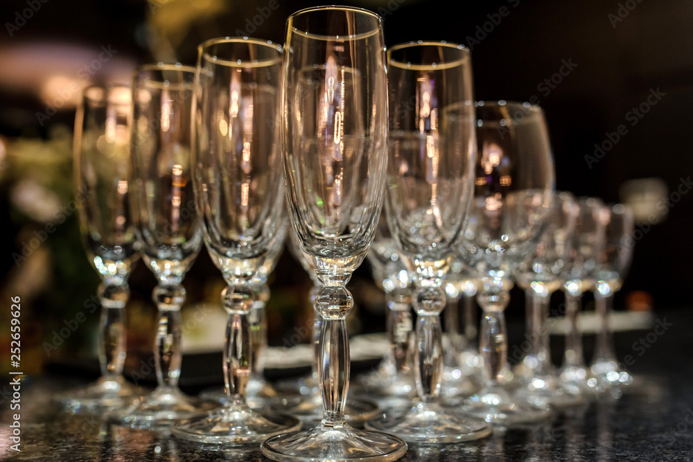 close up photo of rows of empty glasses for champagne on the table close up photo of rows of empty glasses for champagne on the table