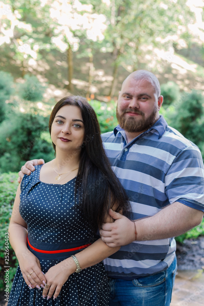Two people in love are standing on a beautiful alley in the park. Two people in love are standing on a beautiful alley in the park.