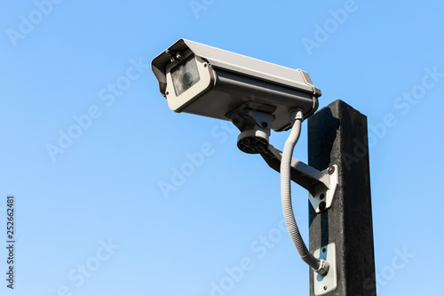 Old closed circuit camera on blue sky background