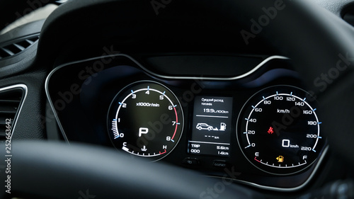 Close-up of a modern dashboard in an expensive car. The steering wheel is blurred. Advanced technology concept