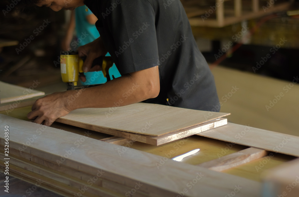 Hand of carpenter working with furniture wood. Hand of carpenter working with furniture wood.