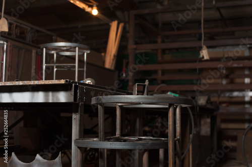 Row of metal chairs in blacksmith workshop © pavel_shishkin