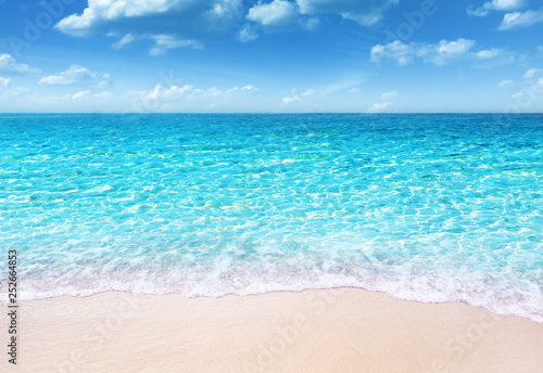tropical sandy beach and soft blue ocean wave summer concept background