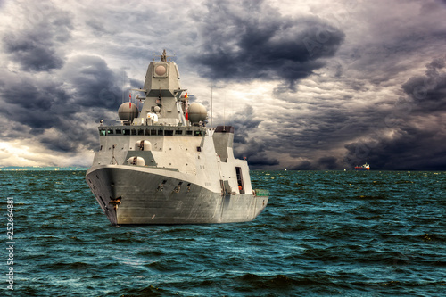 Fotografie Warship on sea of dramatic scenery.