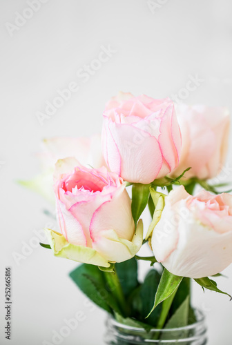Pink roses bouquet, soft delicate roses closeup, spring roses bouquet in a vase