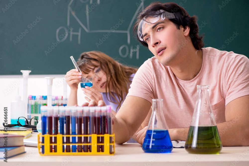 Two chemists students in classroom Two chemists students in classroom