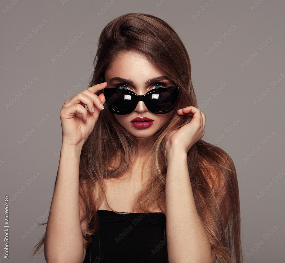Portrait of young woman with long hair wear sunglasses isoalted over ...