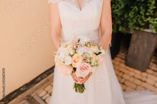 delicate wedding bouquet in the hands of the bride