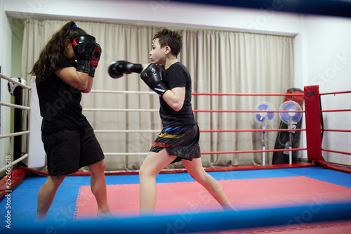 Boy and girl kickboxers in the ring
