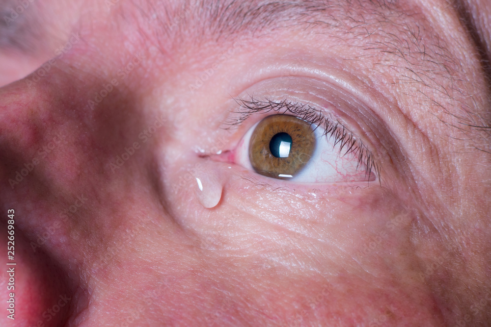 Fototapeta premium Eye of sad man with tear