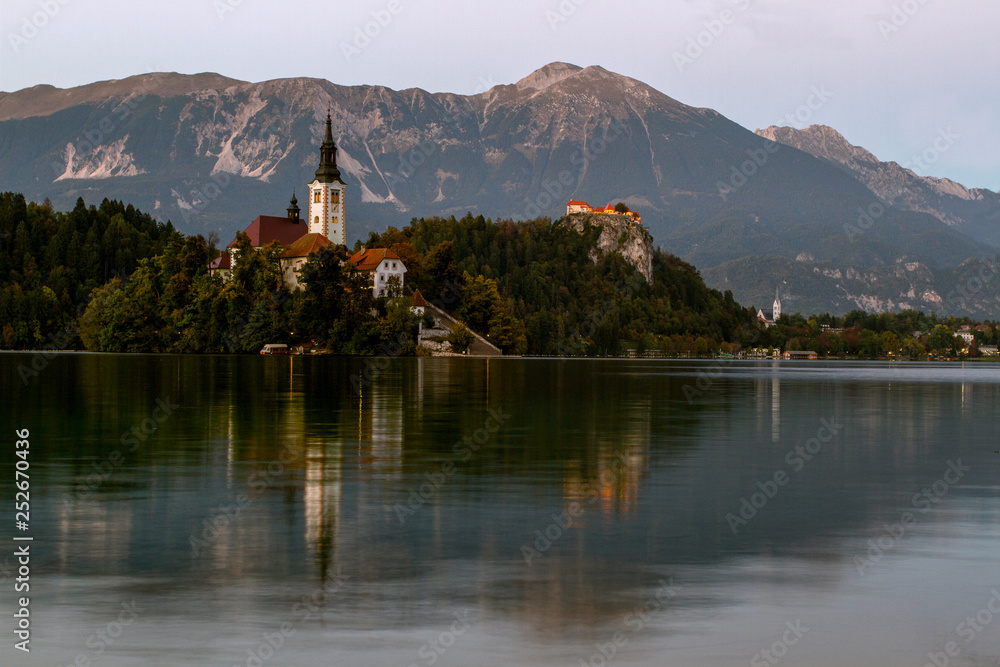 Beautiful mountain lake Bled . Pilgrimage Church of the Assumption of Maria situated on an island . Mountains in background. Slovenia, Europe. European travel. Beautiful mountain lake Bled . Pilgrimage Church of the Assumption of Maria situated on an island . Mountains in background. Slovenia, Europe. European travel.