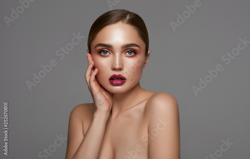 Beautiful face of young pretty girl with clean freash skin isolated over gray background