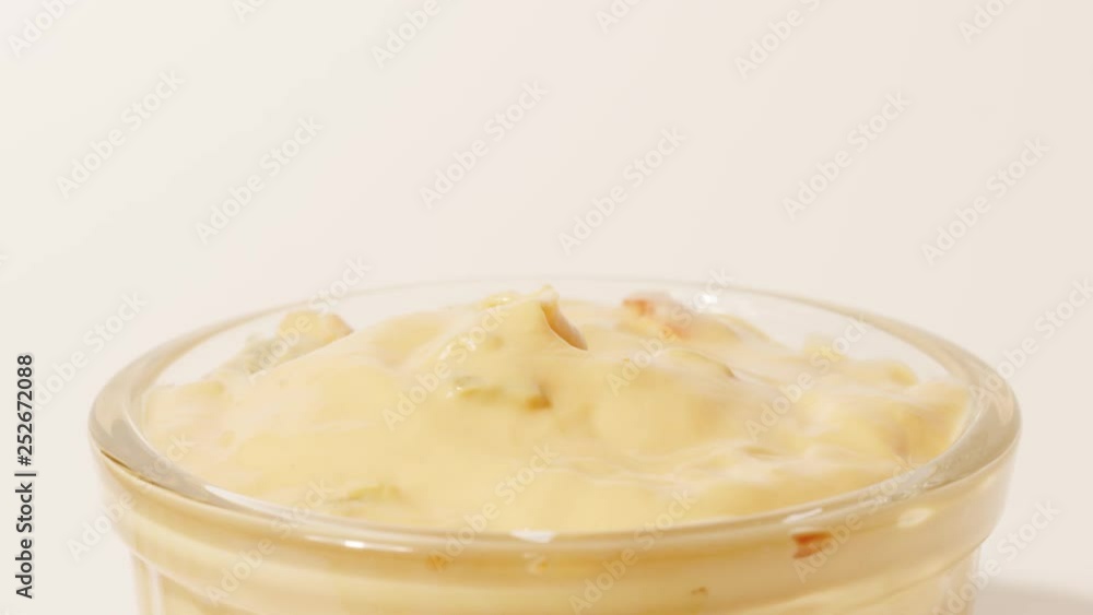 Man dips tortilla chip into cheese sauce, close-up shot Man dips tortilla chip into cheese sauce, close-up shot