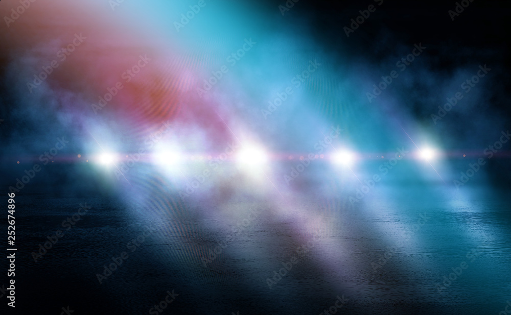 Fototapeta premium Dark empty stage, blue and orange neon spotlight, wet asphalt, smoke, night shooting, rays