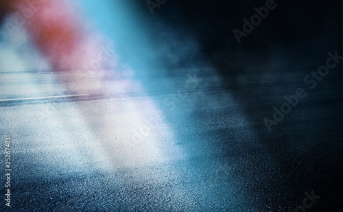 Dark empty stage  blue and orange neon spotlight  wet asphalt  smoke  night shooting  rays