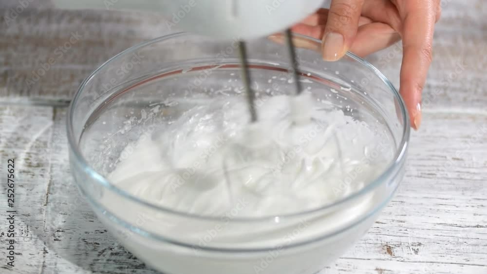 Close-up hand mixer beat the egg whites. Close-up hand mixer beat the egg whites.