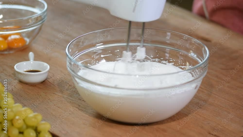 Close-up hand mixer beat the egg whites. Close-up hand mixer beat the egg whites.