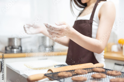 Woman sprinkling flour.