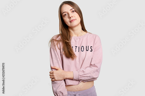 Vászonkép Half length shot of serius contemplative European woman keeps hands partly cross