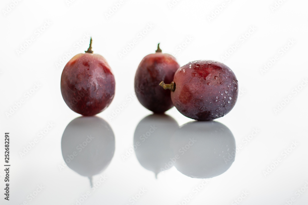 Fototapeta premium Three red grapes isolated