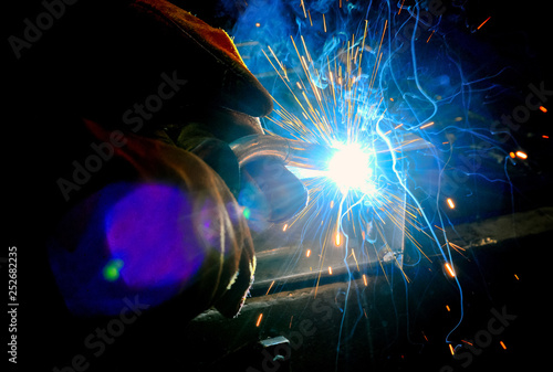 moment of contact of the electrode to the metal electric welding with sparks © Александр Володьков