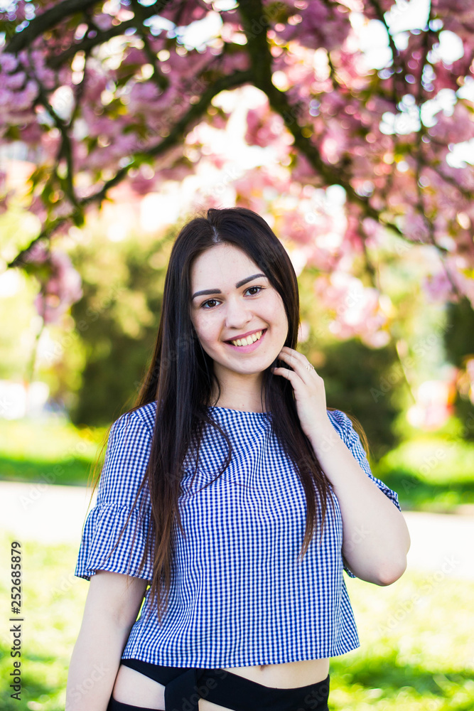 Plus size fashion model in casual clothes, overweight female body in a park outdoors. Spring concept. Plus size fashion model in casual clothes, overweight female body in a park outdoors. Spring concept.
