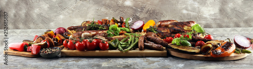 Fototapeta Naklejka Na Ścianę i Meble -  Assorted delicious grilled meat with vegetable on rustic table