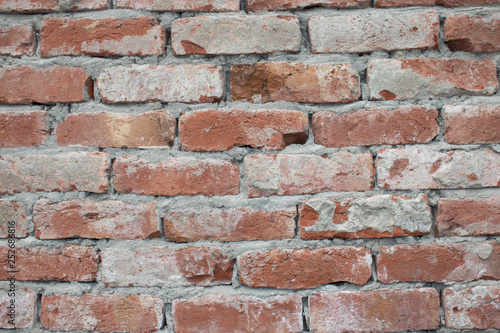 Destroyed brick wall, red texture grunge background