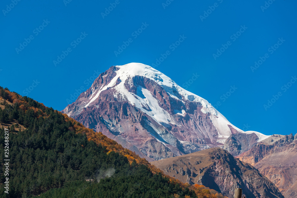 Mount Kazbek (Mkinvartsveri) at sunny day. Caucasus mountains