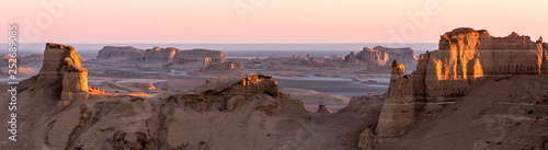 Panoramic view of sandy mountains in Kaluts desert, part of Dasht-e Lut desert during sunrise, Iran
